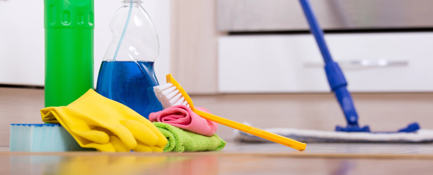 set of cleaning supplies on the floor and mop